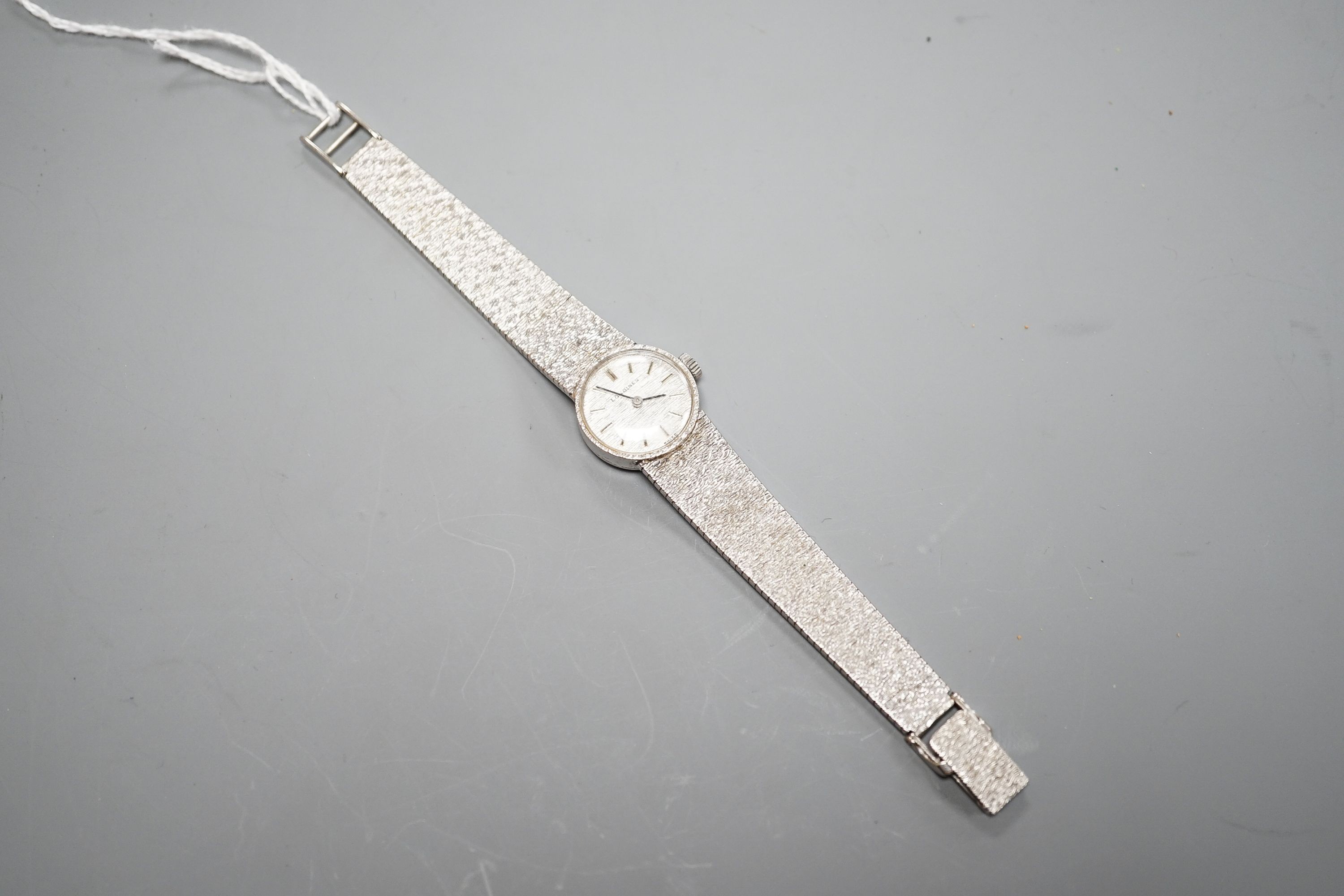 A lady's textured 9ct white gold Longines manual wind wrist watch, case diameter 19mm, overall length 15.2cm